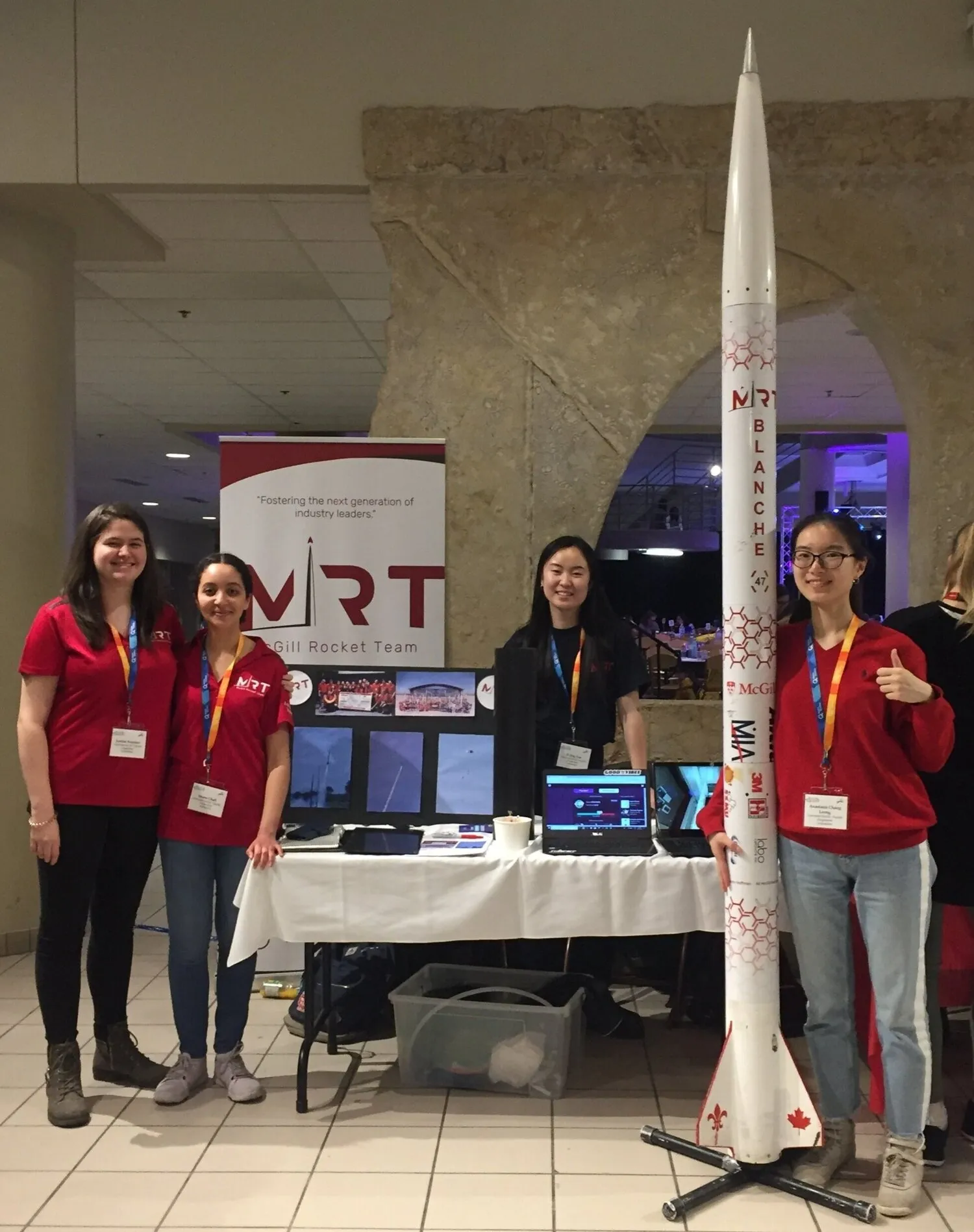 Team members showcasing various rocket team equipment.