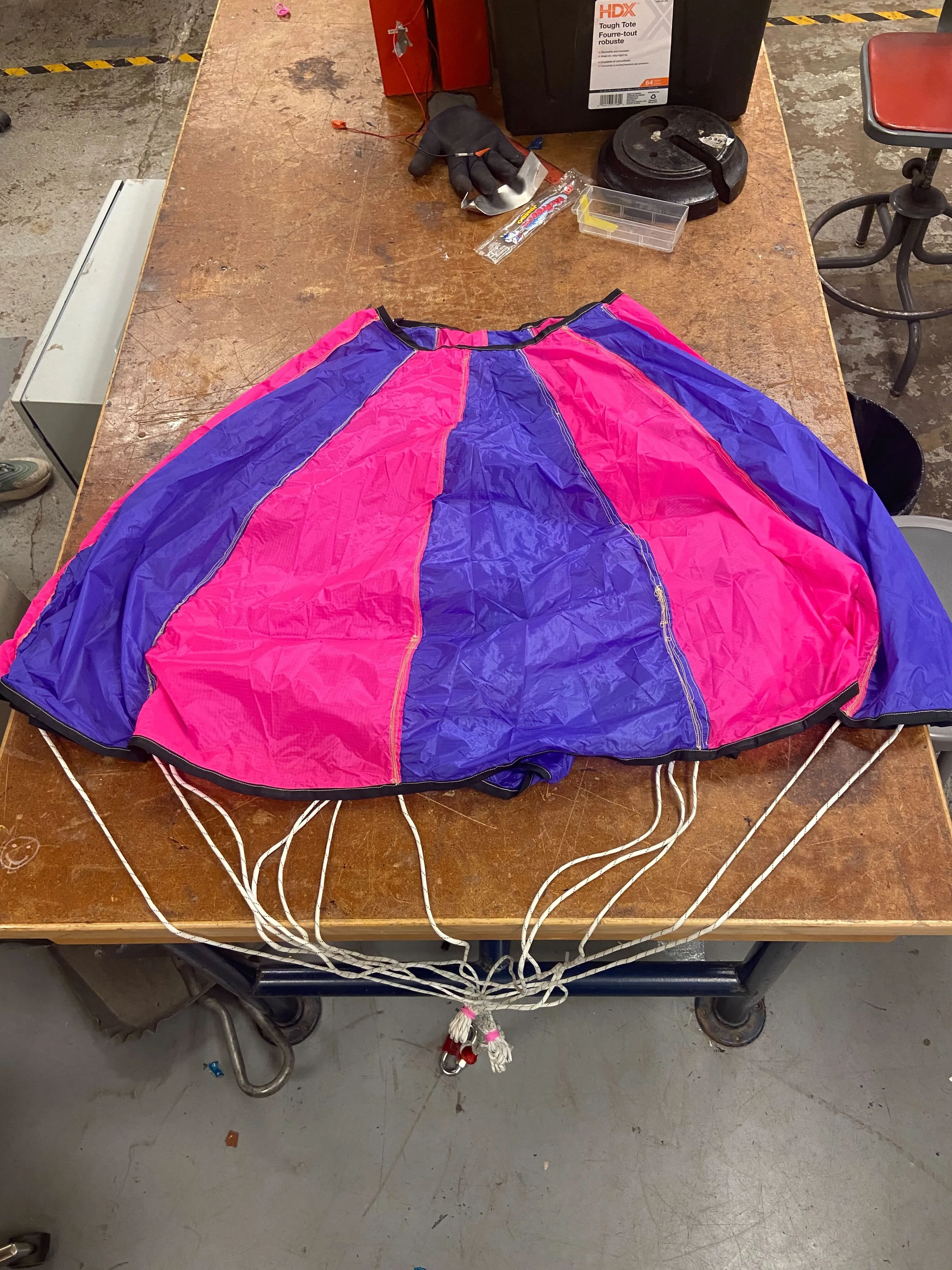 Two team members tabling at an event with a used rocket.